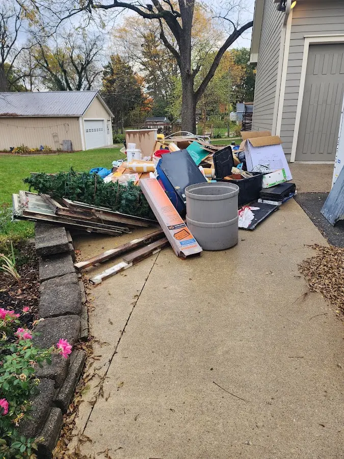 Dumpster being loaded with debris for 3 Yard Dumpster Rental in Pike Creek
